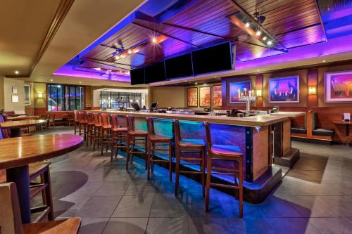 a bar in a restaurant with tables and chairs at Crowne Plaza Dulles Airport by IHG in Herndon