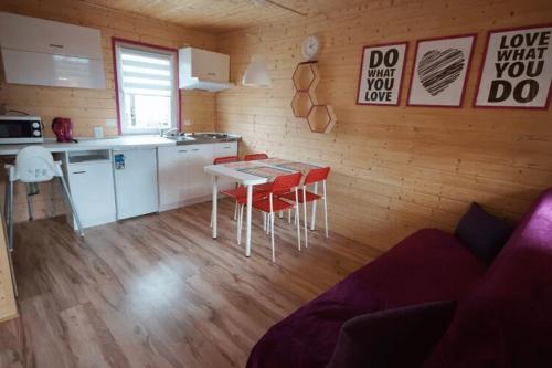 a kitchen with a table and chairs in a room at Leisure complex with a swimming pool Jezierzany in Jezierzany