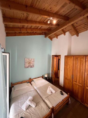 a bedroom with a bed with towels on it at Vagelis house - Gardelades in Corfu Town