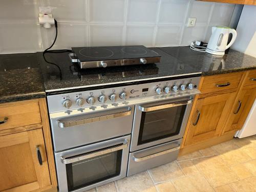 a kitchen with a stove top oven in a kitchen at Vagelis house - Gardelades in Corfu Town