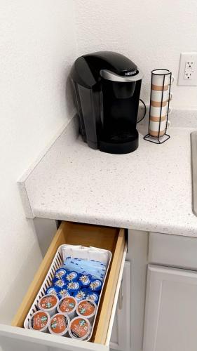 a toaster sitting on top of a counter with cupcakes at Guest House , 5 min away from LAS Airport. in Las Vegas
