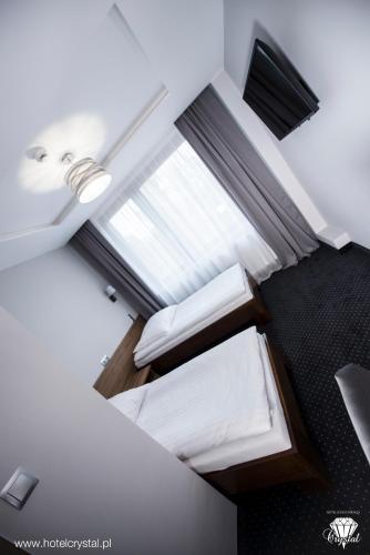 an overhead view of a room with a bed and a window at Hotel Crystal in Janikowo
