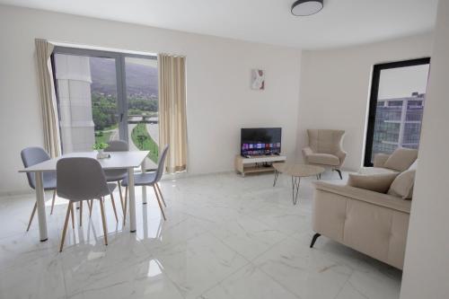 a living room with a table and a couch at Green Eyes Apartments in Sofia