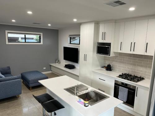 a kitchen with white cabinets and a counter top at A Perfect Place in Seacliff