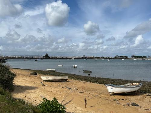 two boats sitting on the shore of a beach at The Gem of Seixal in Seixal