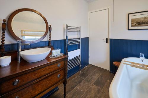 a bathroom with a sink and a mirror on a dresser at Host & Stay - Stone Row in Skinningrove