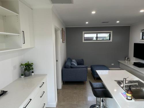 a kitchen and living room with a blue couch in a room at A Perfect Place in Seacliff