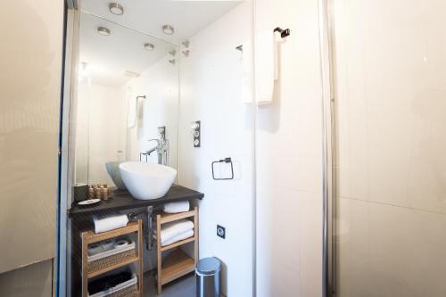 a bathroom with a sink and a shower at El balcón de la vela in Granada