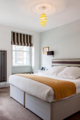 a bedroom with a large bed in a room at The Salutation Inn in Topsham