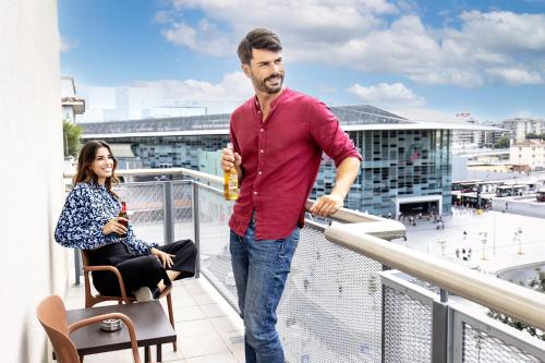 a man and a woman standing on a balcony at Adesso Hotel in Rome