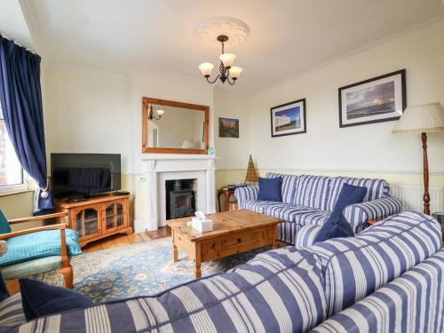 a living room with two couches and a tv at The Pink House in Felixstowe