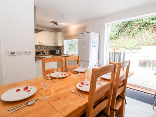 a dining room table with plates and glasses on it at The Pink House in Felixstowe