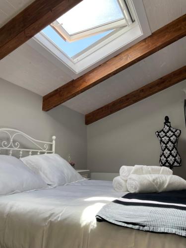 a bedroom with a white bed with a skylight at El Refugio de Haro in Haro