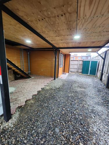 an empty garage with a wooden ceiling and doors at Nui 2 apartamento in Punta Arenas