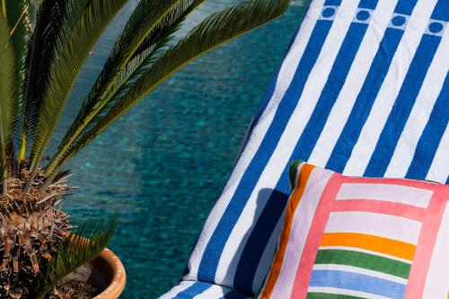 a chair and a plant next to a pool at AC Hotel by Marriott Nice in Nice