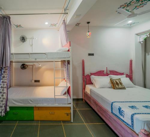 two bunk beds in a room with two beds at Soham Haveli Udaipur in Udaipur