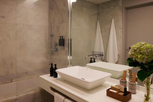 a bathroom with a sink and a shower at Octant Furnas in Furnas