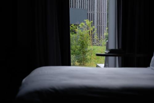 a bedroom with a bed and a window with a view at Octant Furnas in Furnas
