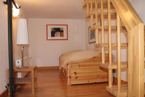 a bedroom with a bunk bed and a spiral staircase at Altes Waschhaus in Putbus