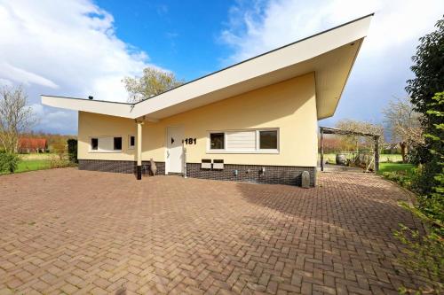 a detached house with a large driveway at Villa Vera in Zeewolde