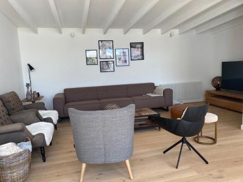 a living room with a couch and chairs at Vakantiehuis Zand7 in Lommel