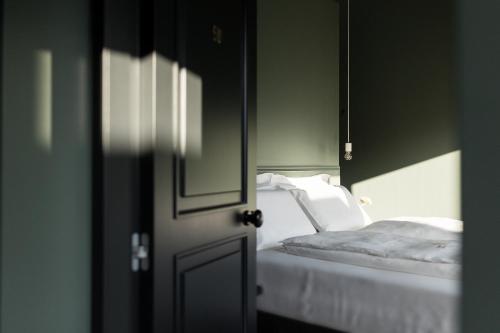 a bedroom with a bed and a mirror and a door at Bucolico Monza in Monza