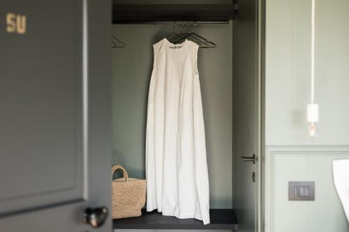 a white dress is hanging in a closet at Bucolico Monza in Monza