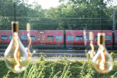 a red train is on the tracks with a bunch ofustedustedustedustedusted at Go Hotel Østerport in Copenhagen