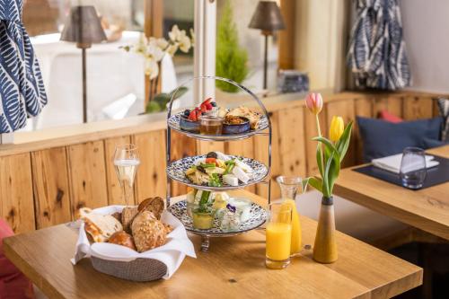 a table with two plates of food and bread at Small Luxury Hotel Goldgasse in Salzburg