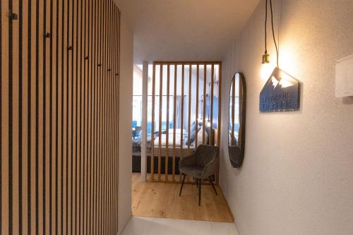 a hallway with a chair and a room with a bedroom at Landhaus Riepler in Wagrain