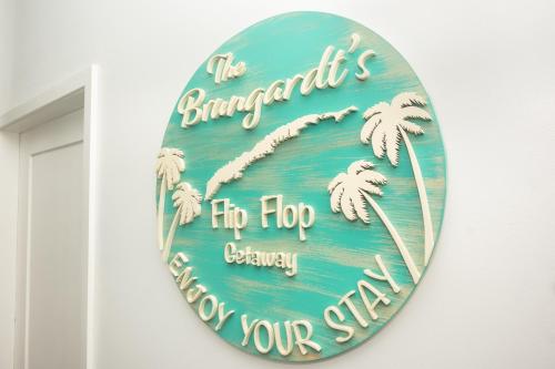 a sign on a wall with palm trees on it at Acqua Di Mare #3 condo in Roatan