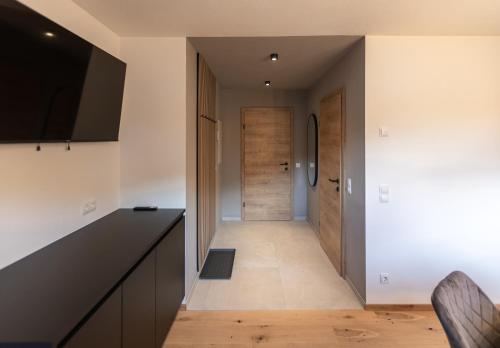 a hallway with a door leading into a kitchen at Landhaus Riepler in Wagrain