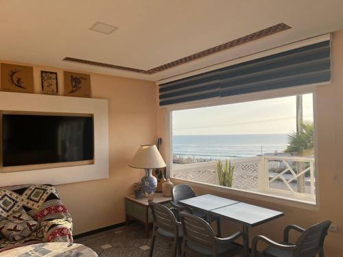 a living room with a view of the ocean at BIG BLUE guest house in Imsouane