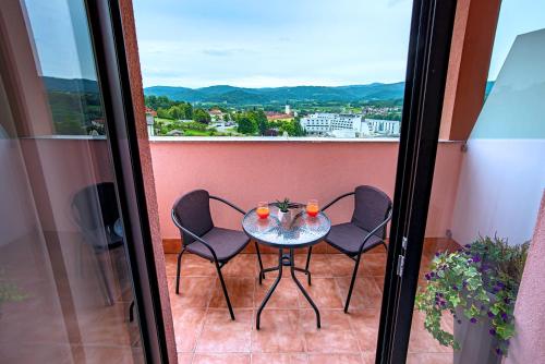 a table and chairs on a balcony with a view at Apartment & rooms Vila Toplissa in Varaždinske Toplice