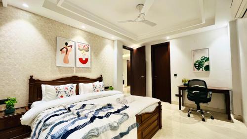 Schlafzimmer mit einem Bett, einem Schreibtisch und einem Stuhl in der Unterkunft Olive Service Apartments - DLF Cyber City in Gurgaon