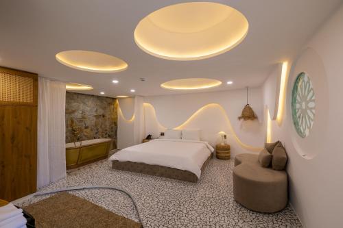 a bedroom with a large bed and a bath room at Pisces Hotel Hue in Hue