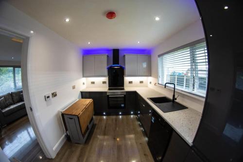 a kitchen with a sink and a counter top at Binevenagh View, Magilligan Holiday Let in Limavady