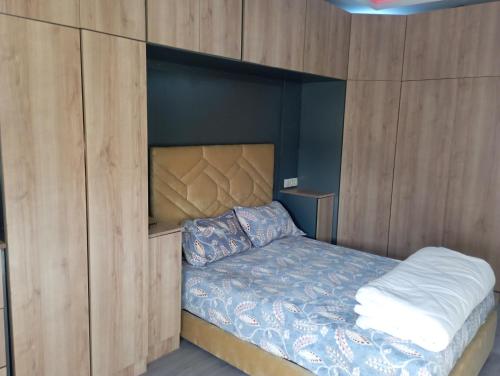 sypialnia z łóżkiem w drewnianej ścianie w obiekcie حرية w mieście Aïn Chock