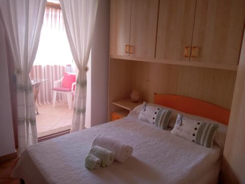 Ένα ή περισσότερα κρεβάτια σε δωμάτιο στο casa vacanza Rosanna