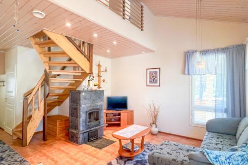 a living room with a staircase and a fireplace at Lomahuoneisto Kalajoen Hiekat B 4 in Kalajoki