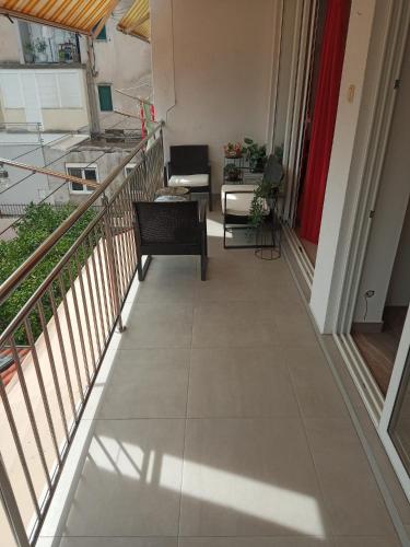 a balcony with a view of a living room at Sunshower apartment and studio in Split