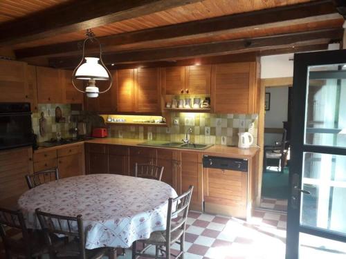 a kitchen with a table and a table and chairs at Maison avec rivière entre Genève et Annecy in Chanay