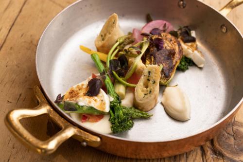 a plate of food in a pan on a table at Small Luxury Hotel Goldgasse in Salzburg