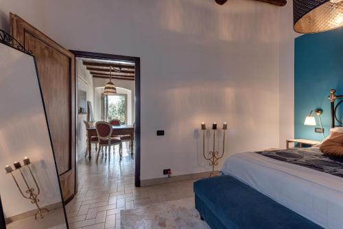 a bedroom with a bed and a dining room at Poggio al Mandorlo in Greve in Chianti