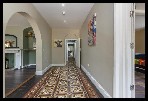 a hallway with a rug on the floor at Stubbs House, Loddon, sleeps 20, 2 hot tubs in Loddon
