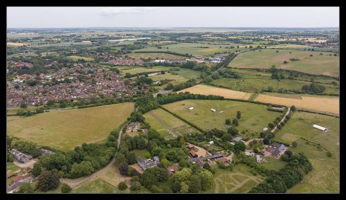 an aerial view of a village in a field at Stubbs House, Loddon, sleeps 20, 2 hot tubs in Loddon