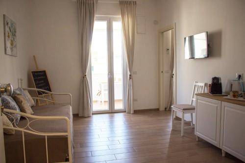 a living room with a couch and a sliding glass door at Boga & Vopa House in Savelletri di Fasano