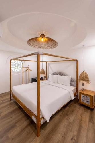 a bedroom with a large bed with a white comforter at Pisces Hotel Hue in Hue