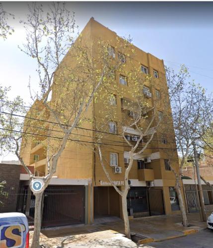 a tall building with trees in front of it at Departamento Santa Fe Oeste del Bicentenario in San Juan