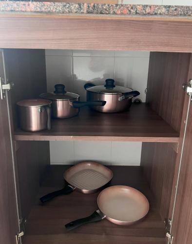 a kitchen with pots and pans on a shelf at Departamento Santa Fe Oeste del Bicentenario in San Juan